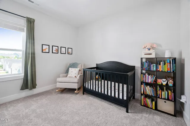 a bedroom with a bed and a book shelf