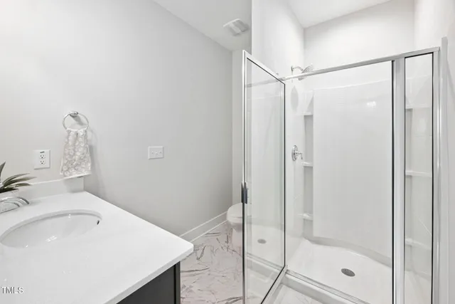a bathroom with a sink and shower
