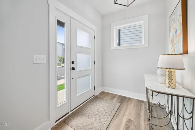 a view of an entryway with wooden floor