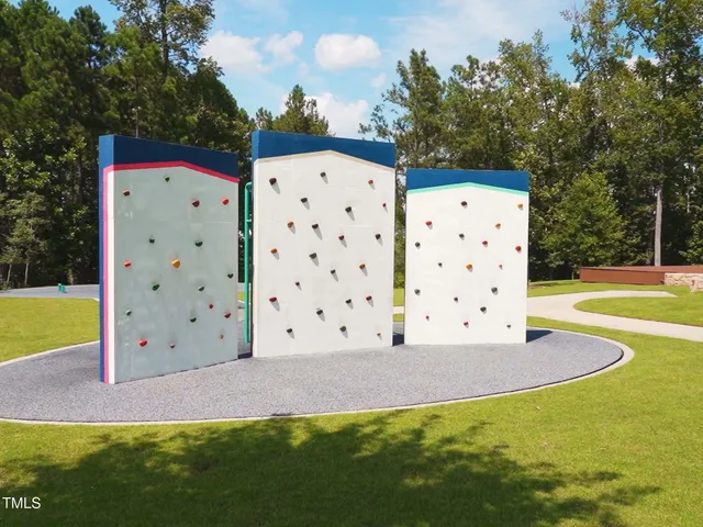 a view of swimming pool with a patio and yard