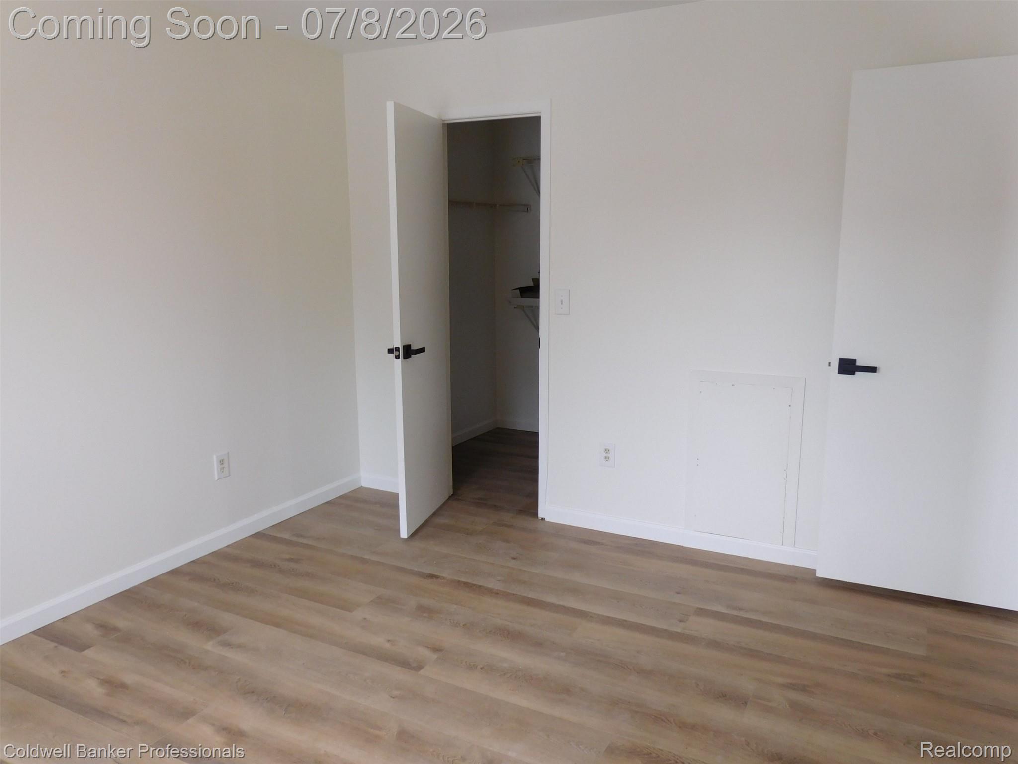 284 East 13 Mile Road Madison Heights, MI 48071 - Photo 12 of 21 Interior room featuring wood-finish flooring, white baseboards, and light-colored walls