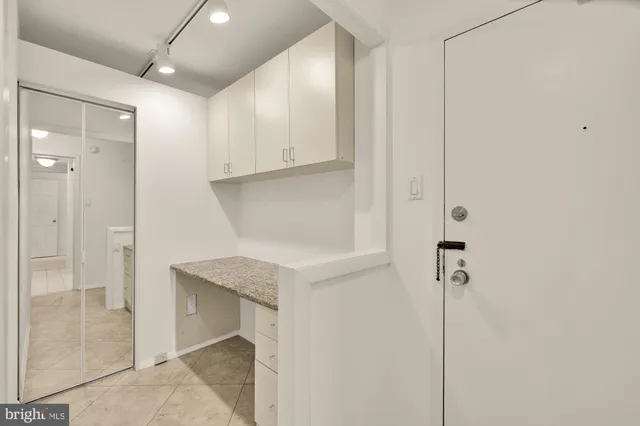 a view of kitchen with sink refrigerator and window