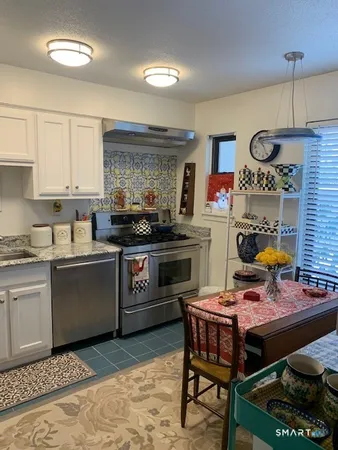 a kitchen with a refrigerator and a stove top oven