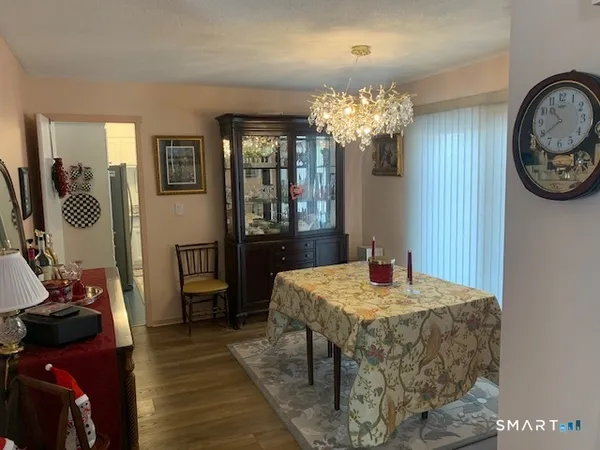 a view of a dining room with furniture and a chandelier