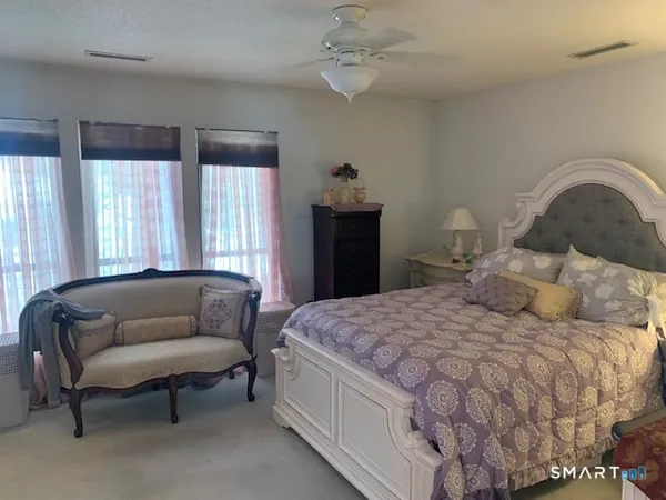 a bedroom with a bed and a couch