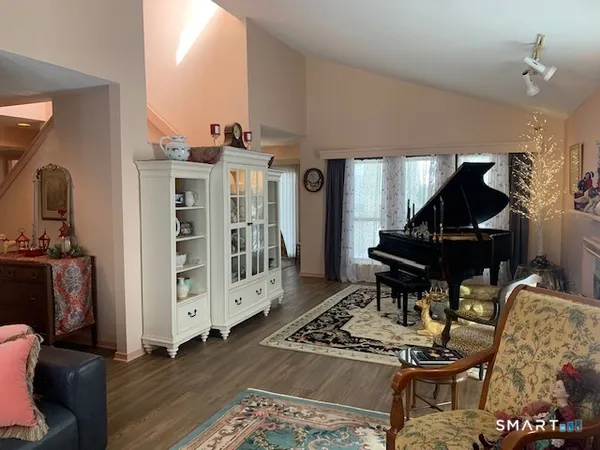 a living room with furniture and wooden floor