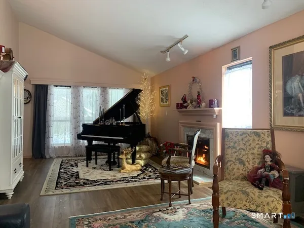 a living room with furniture and a piano