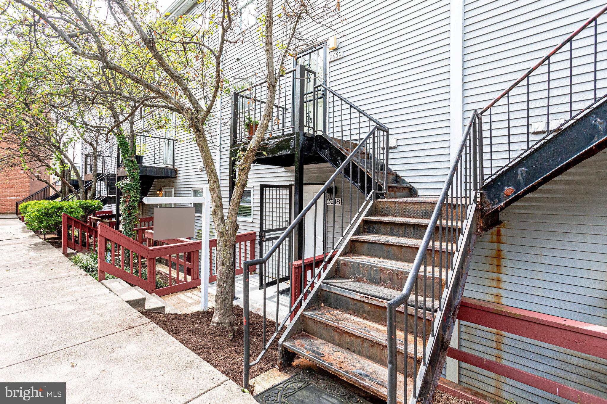2648 Bowen Road Southeast Washington, DC 20020 - Photo 2 of 36 a view of a house with wooden deck stairs and a large tree