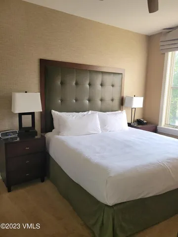 a bedroom with a bed and a lamp