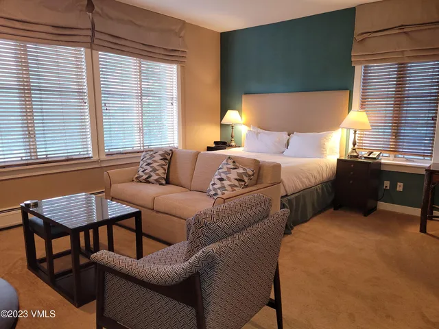 a bedroom with two beds and a couch