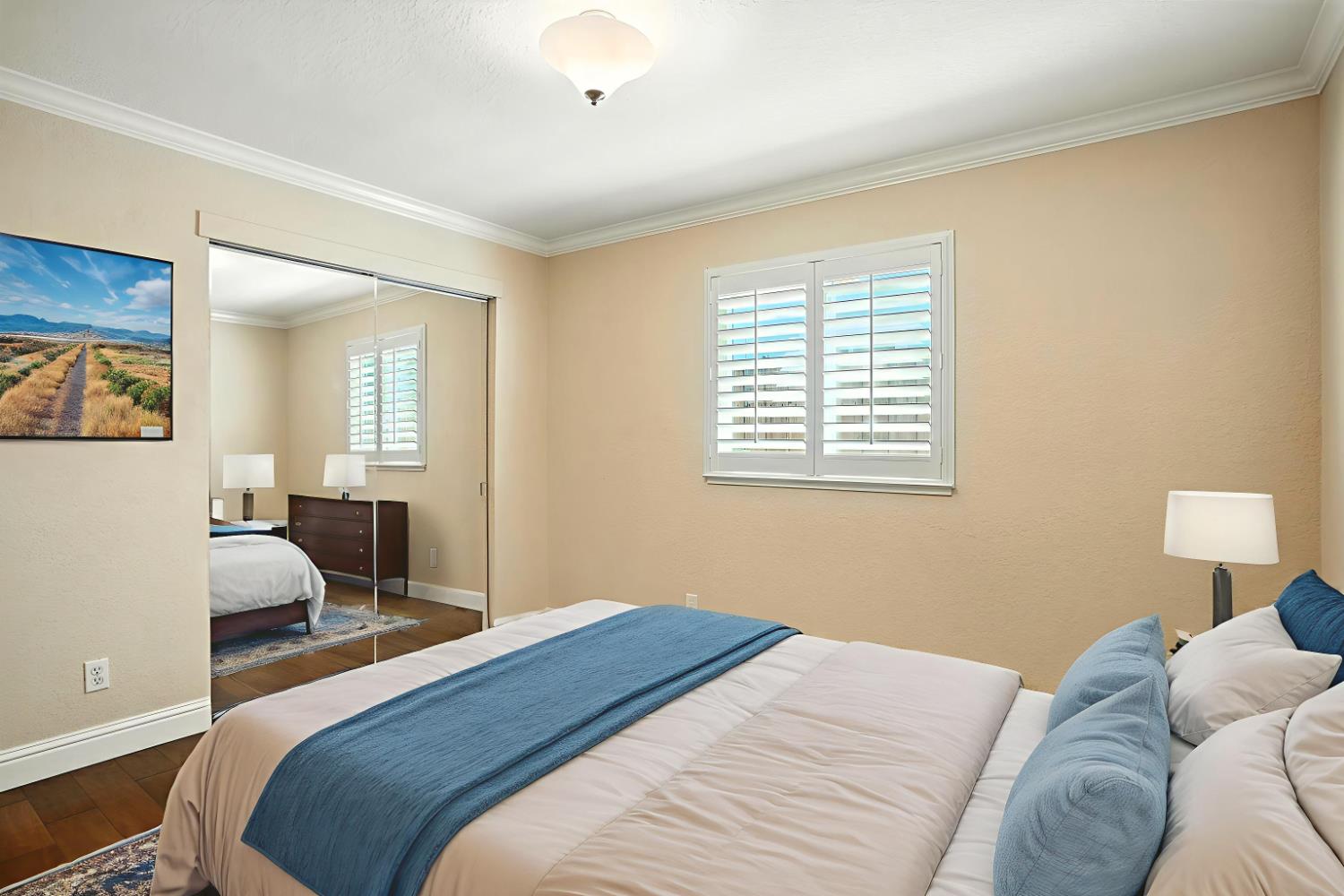 906 Ranch Road Galt, CA 95632 - Photo 21 of 37 Virtuallly staged bedroom featuring ornamental molding, a closet, and wood finished floors