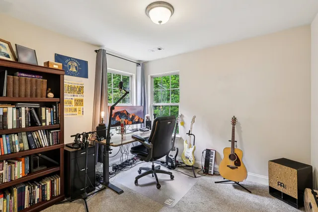a view of a workspace with furniture and a bookshelf