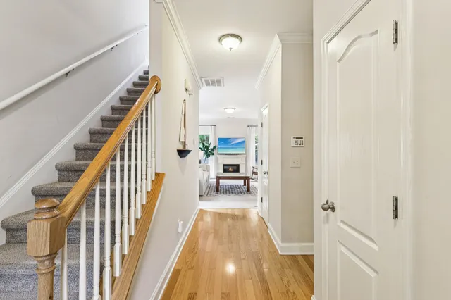 a view of a hallway view with wooden floor and staircase