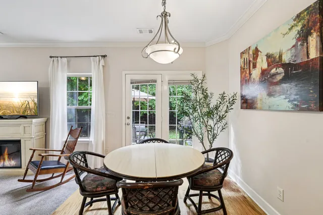 a view of a dining room with furniture window and wooden floor