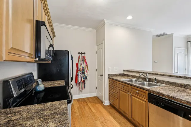 a kitchen with a sink stove and refrigerator