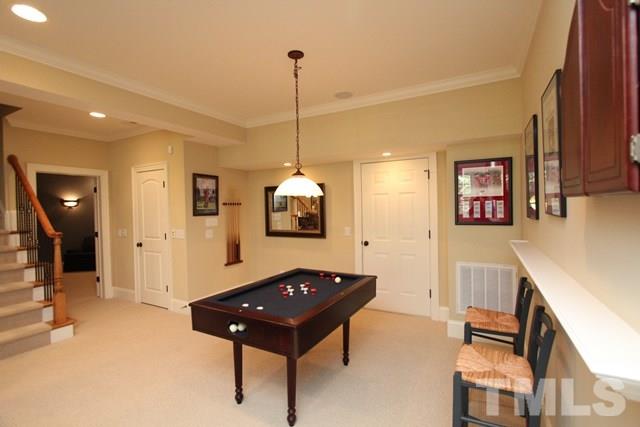 7112 Trenton Ridge Court Raleigh, NC 27613 - Photo 22 of 25 a living room with a couch and a chandelier