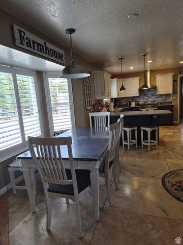 1697 West 2450 Vernal, UT 84078 - Photo 10 of 36 Dining room featuring recessed lighting, a textured ceiling, and concrete flooring
