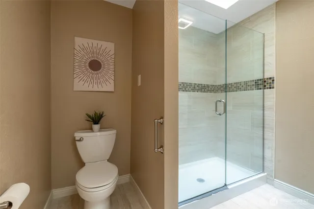 a a bathroom with a toilet and a shower