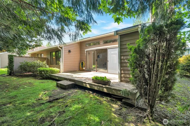 a view of a house with backyard and sitting area