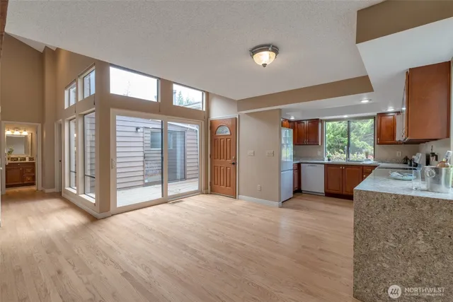 a view of a kitchen with a sink and a large window