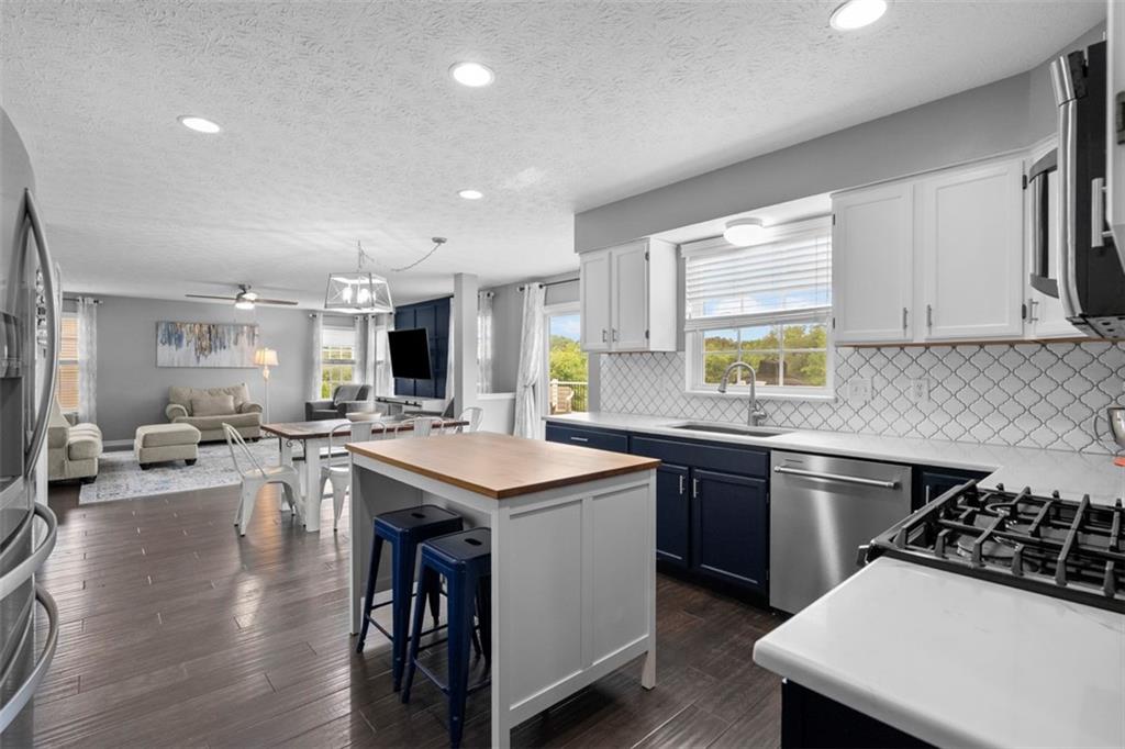 145 Brighton Lane Mars, PA 16046 - Photo 17 of 44 a kitchen with lots of counter top space a sink appliances and cabinets
