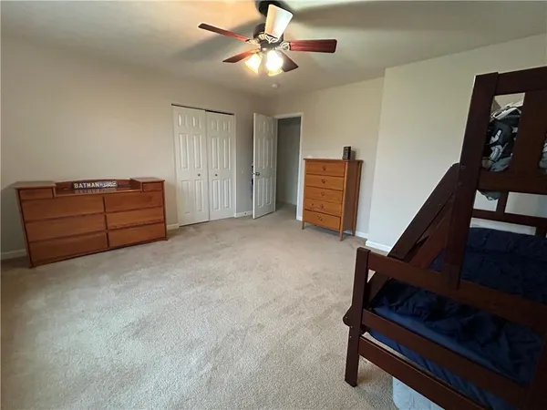 a living room with furniture and a ceiling fan