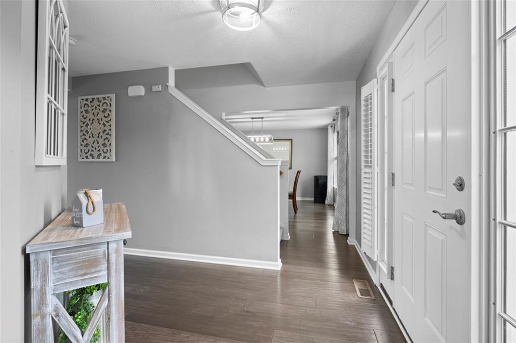 145 Brighton Lane Mars, PA 16046 - Photo 4 of 44 a view of a hallway with wooden floor and staircase