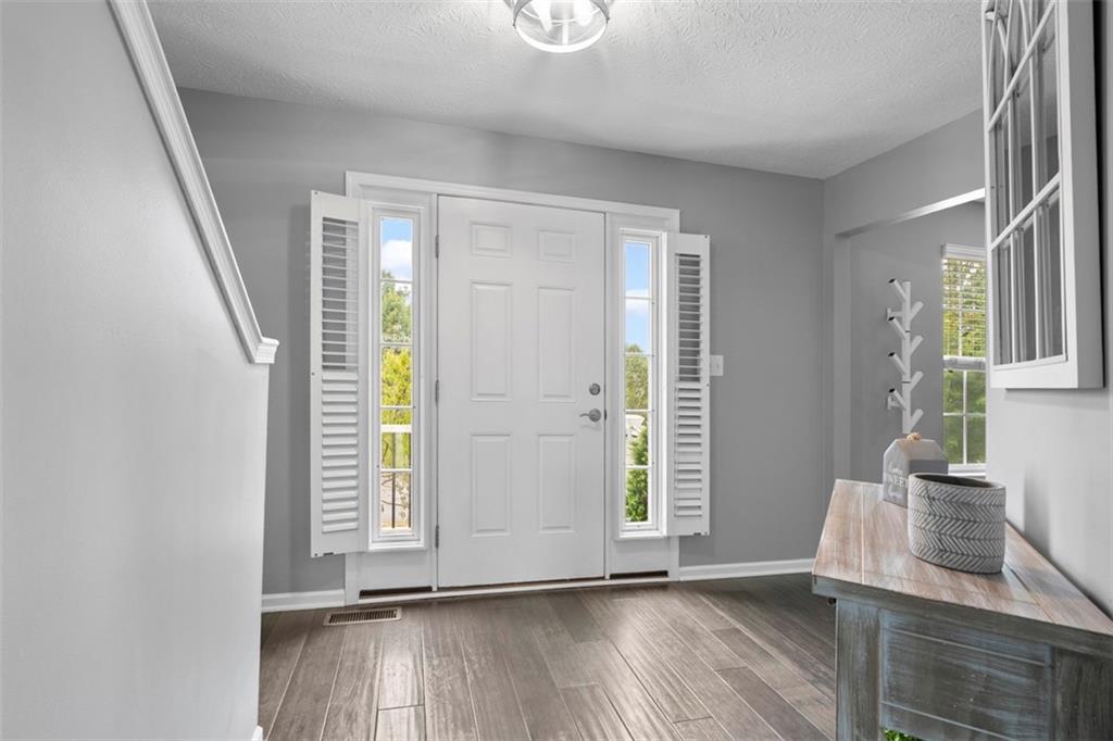 145 Brighton Lane Mars, PA 16046 - Photo 6 of 44 an entryway with wooden floor and cabinet