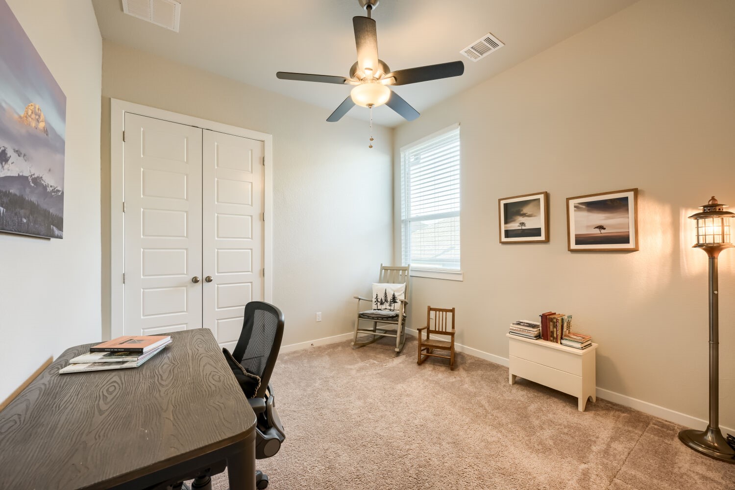 621 Rancho Sienna Loop Georgetown, TX 78628 - Photo 22 of 28 A well-lit study with a plush carpet floor features a ceiling fan and a window for natural light.