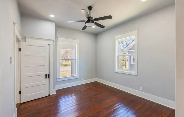 a view of empty room with wooden floor