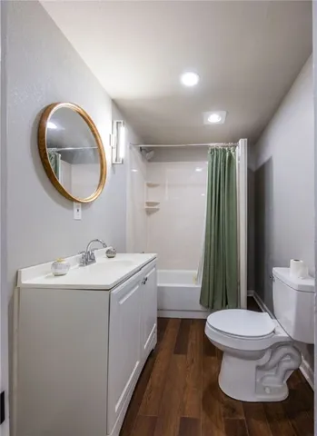 a view of hallway with window and wooden floor