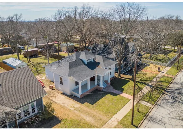 an aerial view of residential houses with outdoor space