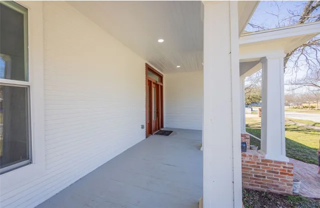 a view of an entryway with wooden floor and door