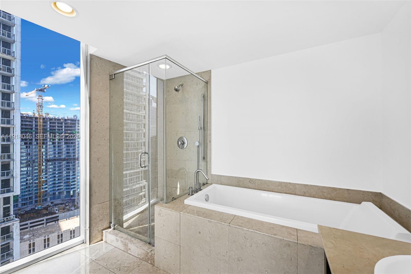 475 Brickell Avenue, Unit 3113 Miami, FL 33131 - Photo 13 of 28 a bathroom with a tub shower and sink