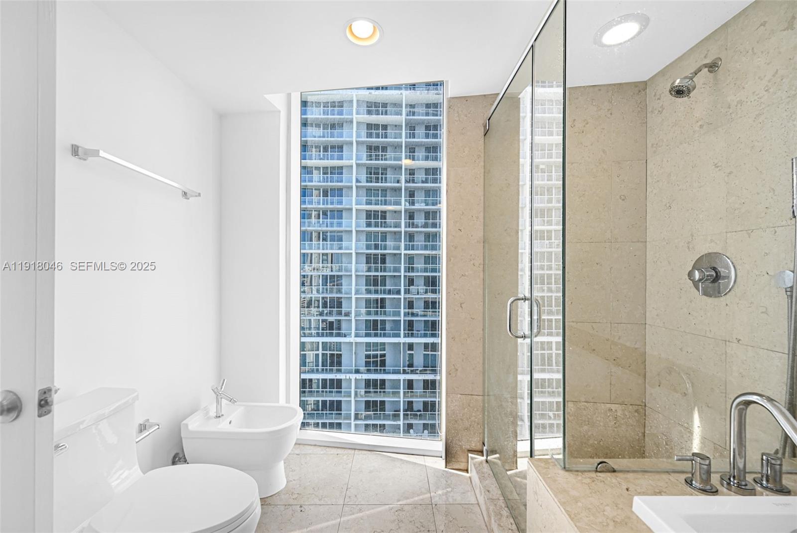 475 Brickell Avenue, Unit 3113 Miami, FL 33131 - Photo 14 of 28 a bathroom with a toilet shower and a sink