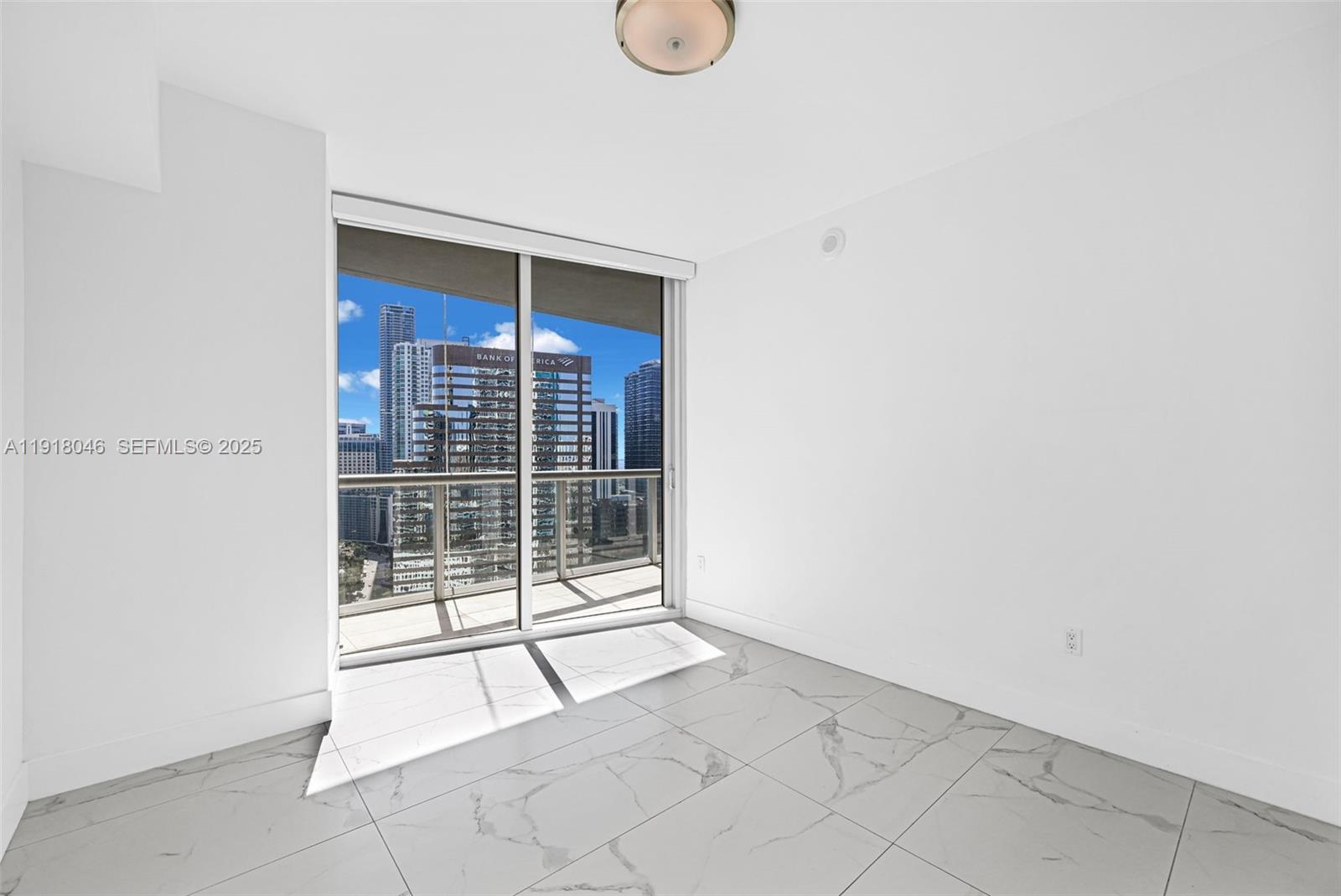 475 Brickell Avenue, Unit 3113 Miami, FL 33131 - Photo 22 of 28 a view of an empty room with wooden floor and a window