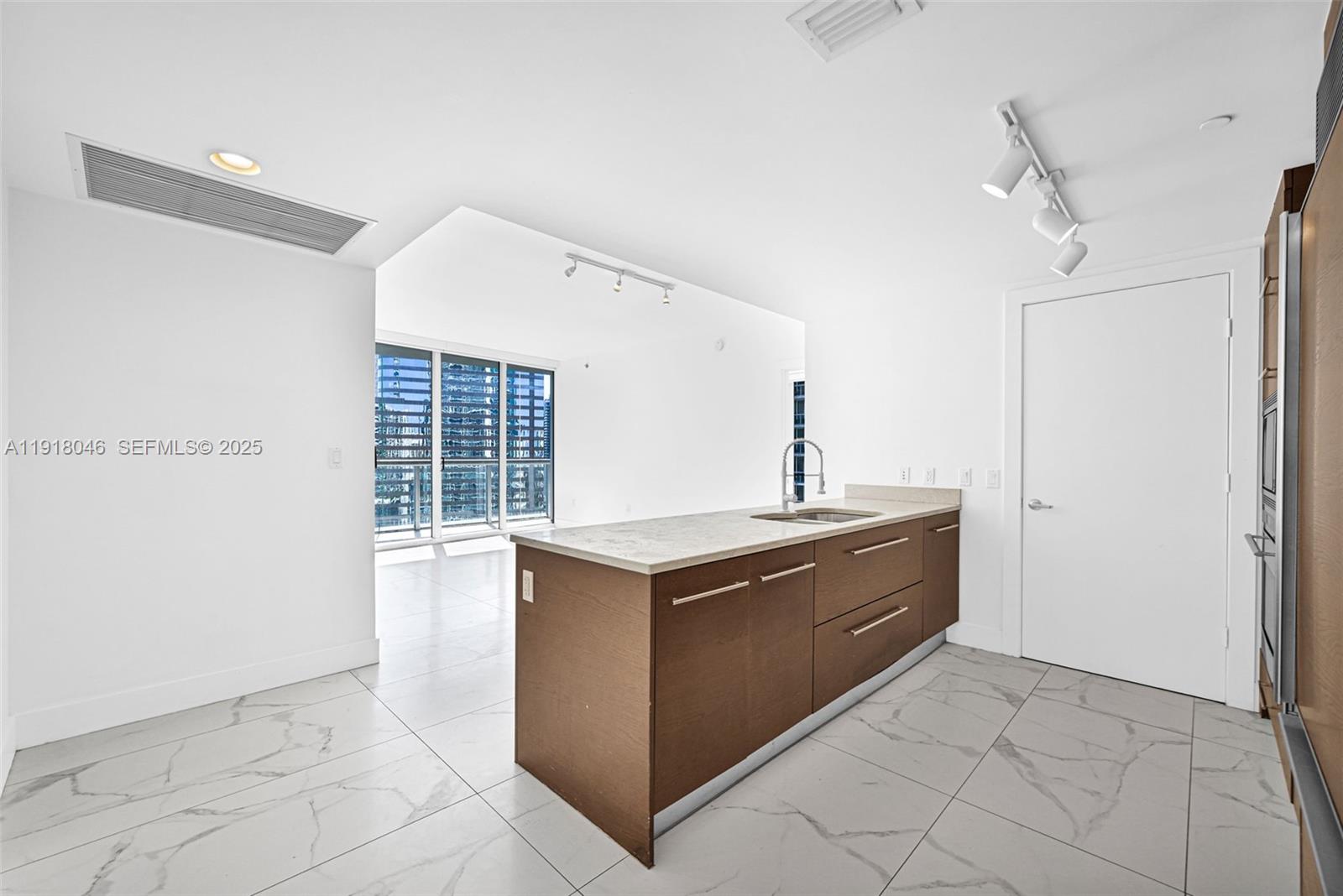 475 Brickell Avenue, Unit 3113 Miami, FL 33131 - Photo 6 of 28 a kitchen with stainless steel appliances granite countertop a sink and a stove