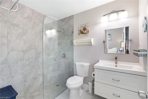 a bathroom with a toilet sink and shower