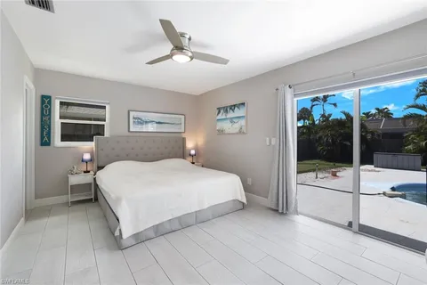 a bedroom with a large bed and a flat tv screen