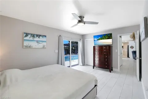 a bedroom with a large bed and a chandelier