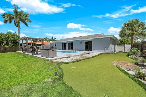 a swimming pool with outdoor seating and yard