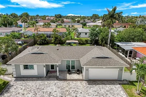 an aerial view of a house with a yard and sitting space