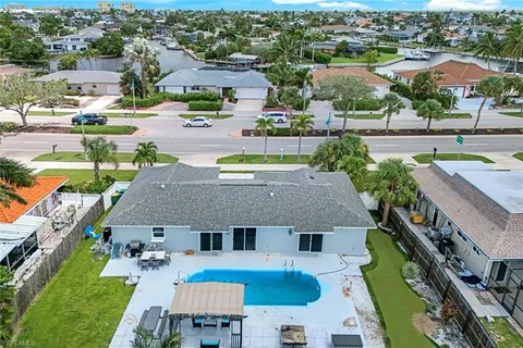 an aerial view of residential houses with outdoor space and parking
