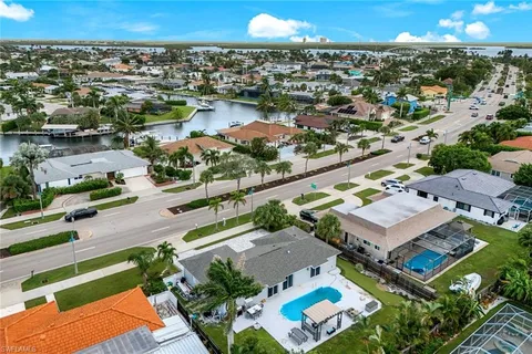 an aerial view of a house with a lake view