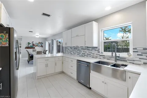 a kitchen with sink and cabinets