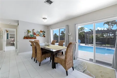 a view of a dining room with furniture and window