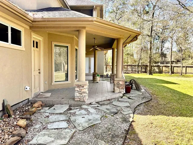 a view of a porch with furniture and floor to ceiling windows