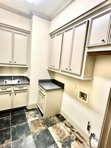 a kitchen with a stove a sink and a microwave