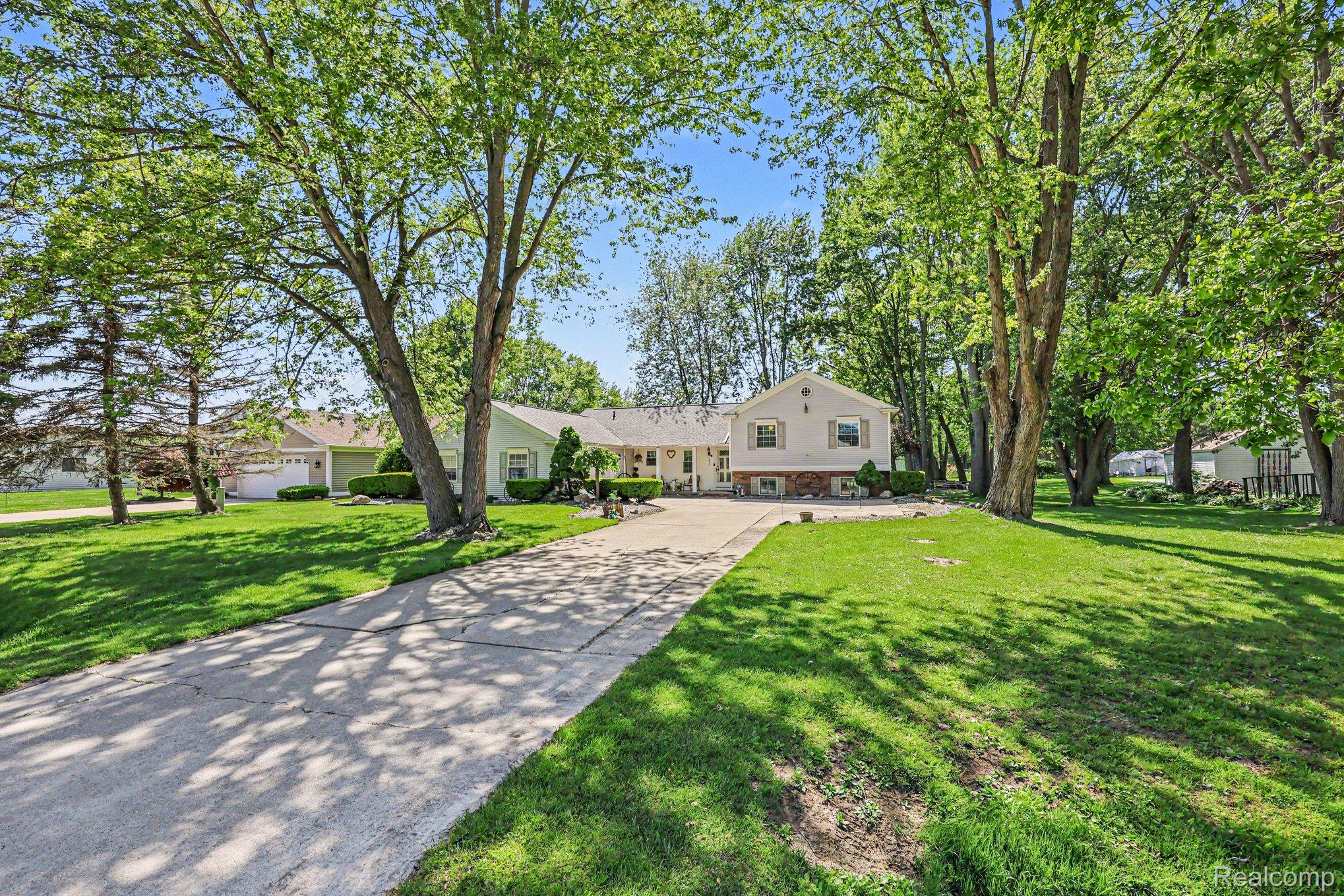 7020 Meldrum Road Fair Haven, MI 48023 - Photo 30 of 43 Expansive front lawn with mature trees and a concrete driveway