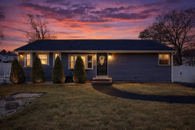 a view of house with backyard space and balcony